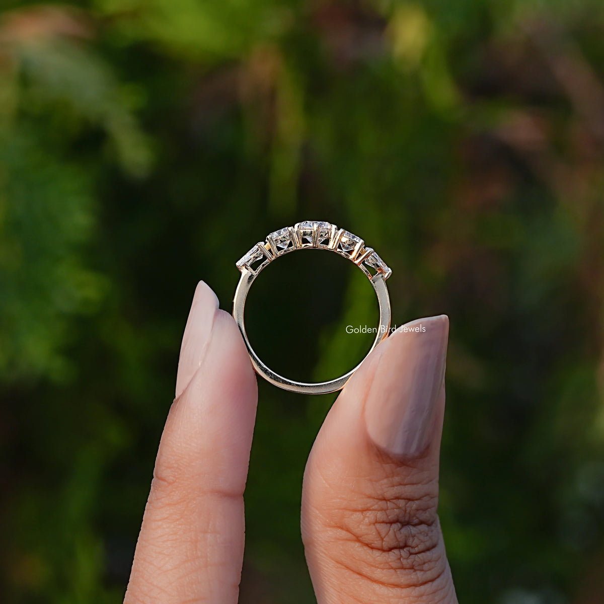 Back View of Round And Pear Cut Lab Diamond Ring In two fingers