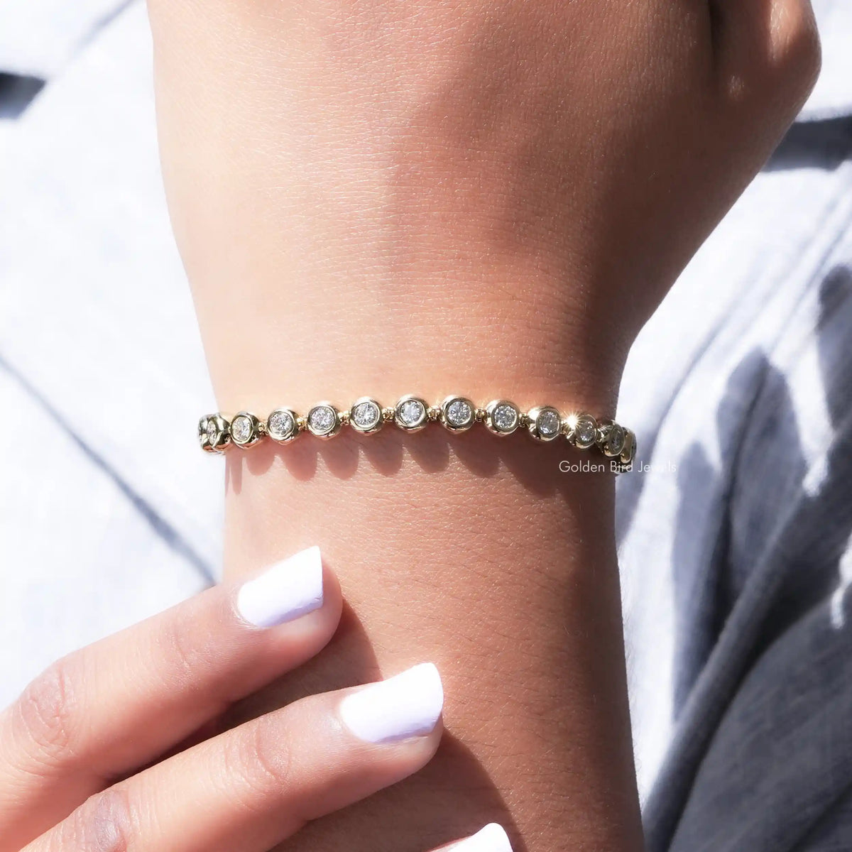 Moissanite bezel setting bracelet with round stones across the wrist