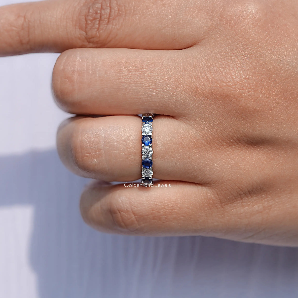 Close View Of Blue Round Cut Gemstone Eternity Band
