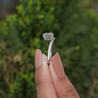 Silver curved solitaire ring with round lab diamond in a sculpted prong crown