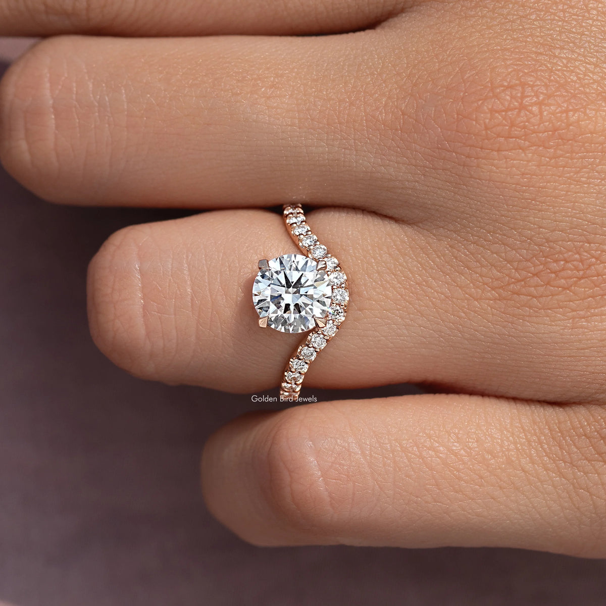 Round cut engagement ring with curved pavé accent band