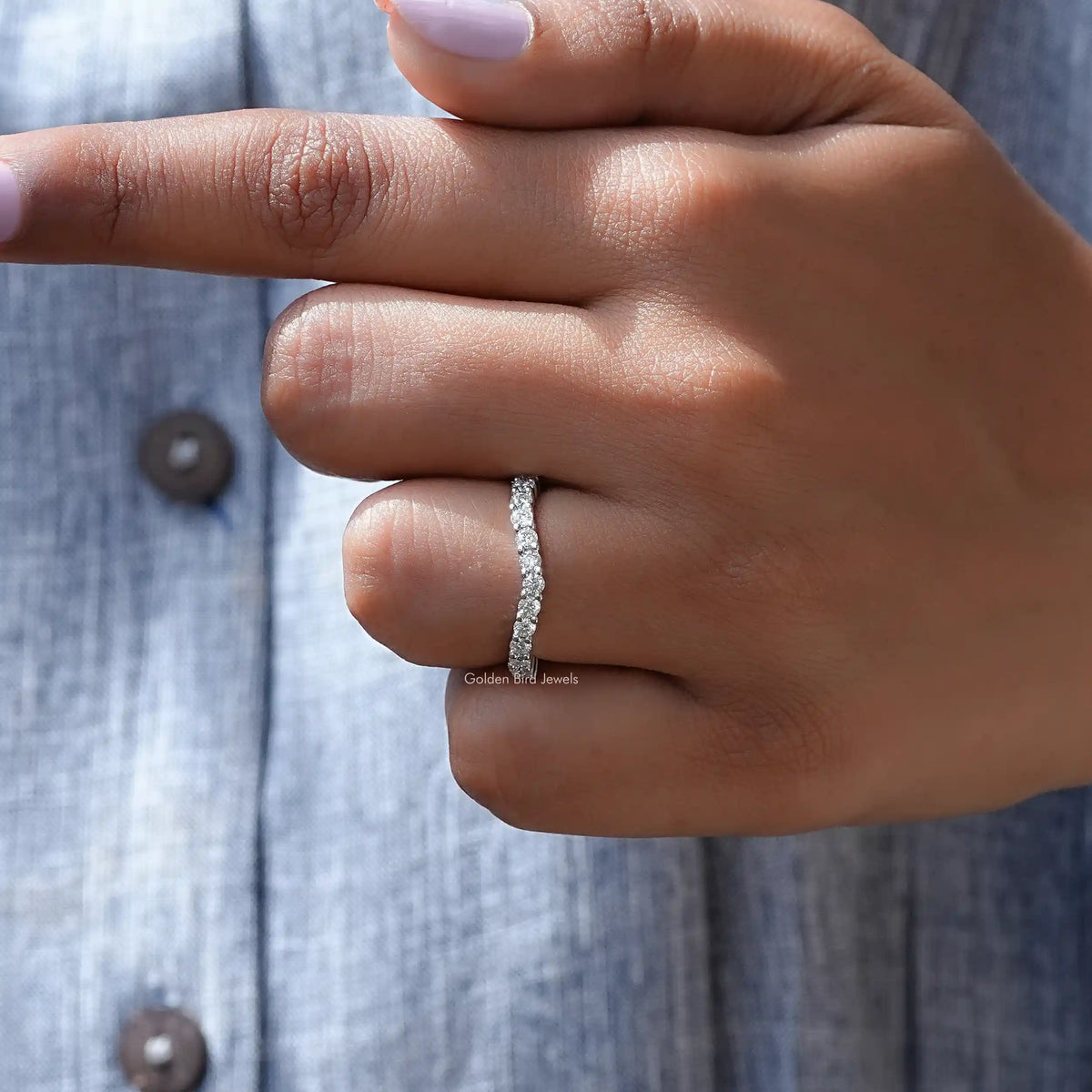 Silver diamond chevron stacking band ring close-up on finger