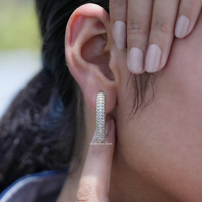 Round cut lab diamond pave-set hoop earring on an ear piercing