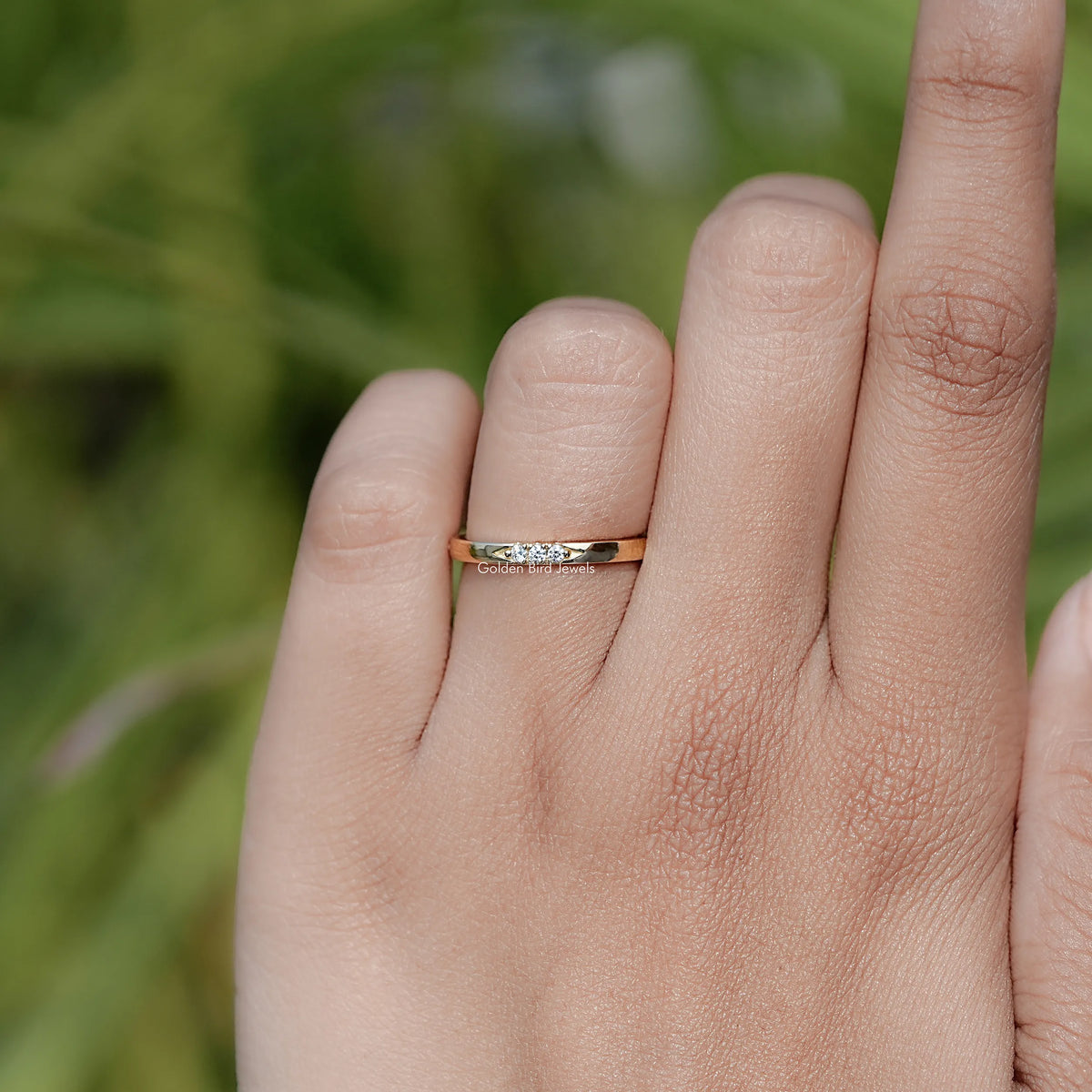 Yellow gold-tone eternity band ring with round-cut diamonds, thin close-up