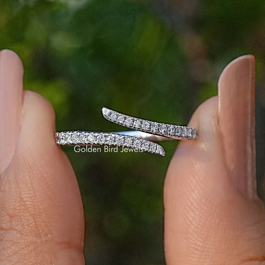 Open cuff ring with round cut lab diamonds along the top, angled on fingers