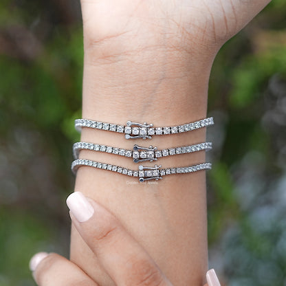 Silver tennis bracelet set with round diamond stones and small square clasp