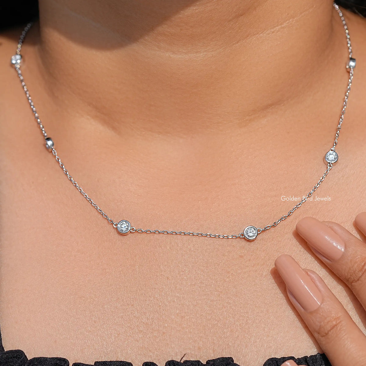 Silver chain necklace with three round lab diamond-like bezel stones on choker length