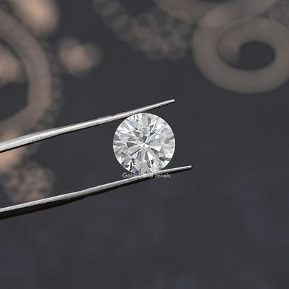 Loose round-cut lab diamond in silver tweezers, face-up sparkle view