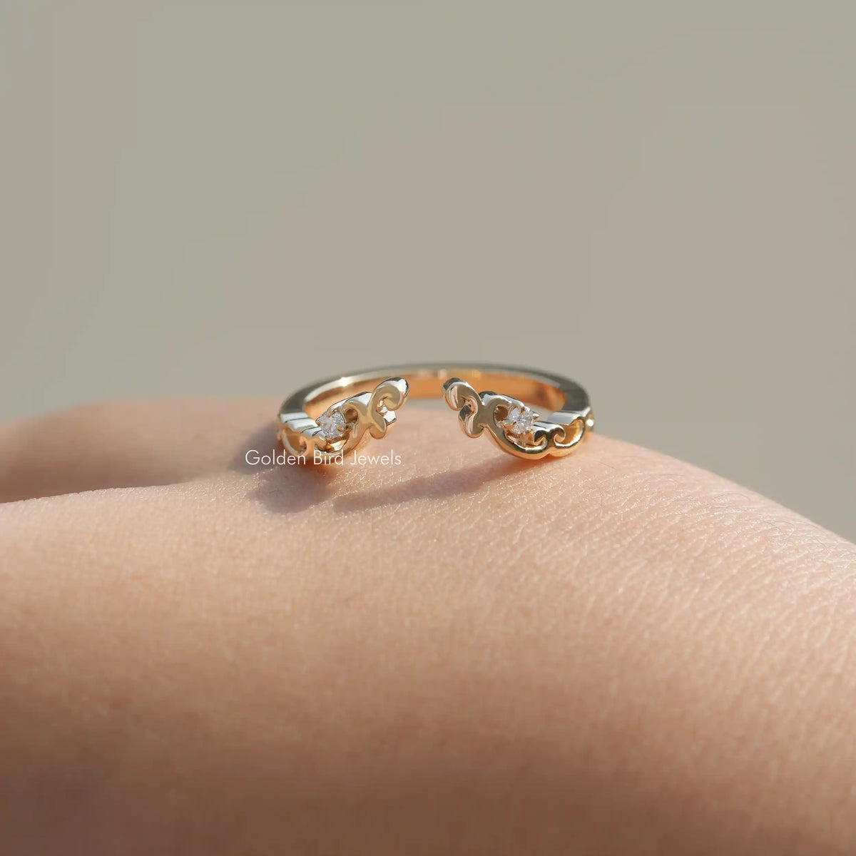 Gold-tone open cuff stacking band ring with round lab diamonds, angled on skin