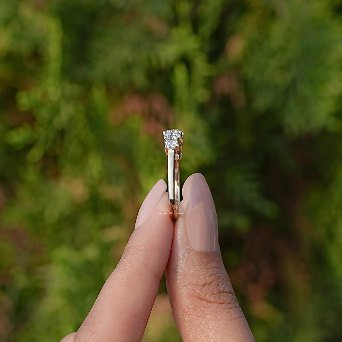 Side View of Round Cut Lab Grown Diamond Ring In two fingers