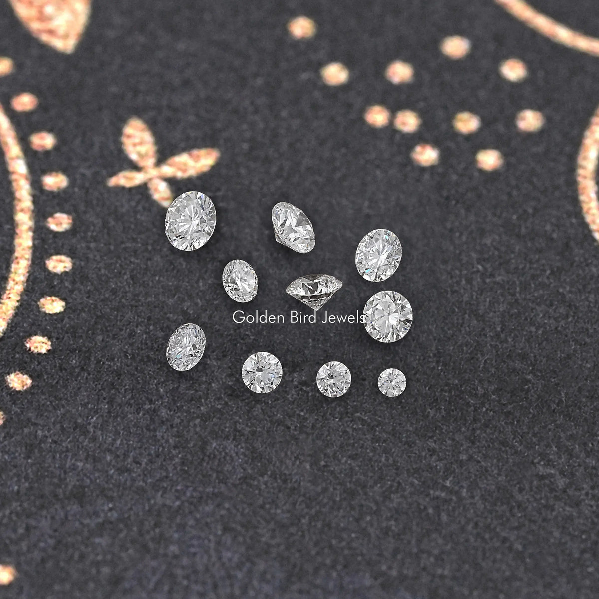 Multiple loose round-cut lab diamonds on dark cloth, assorted sizes