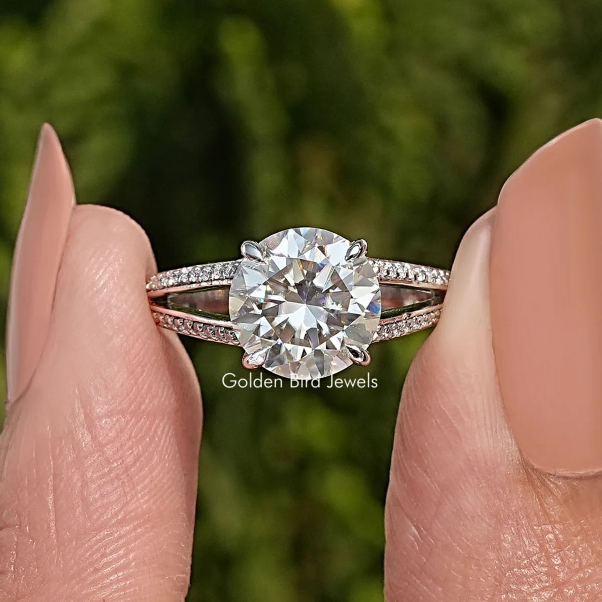 Round-cut moissanite engagement ring with split shank and pavé accents in silver