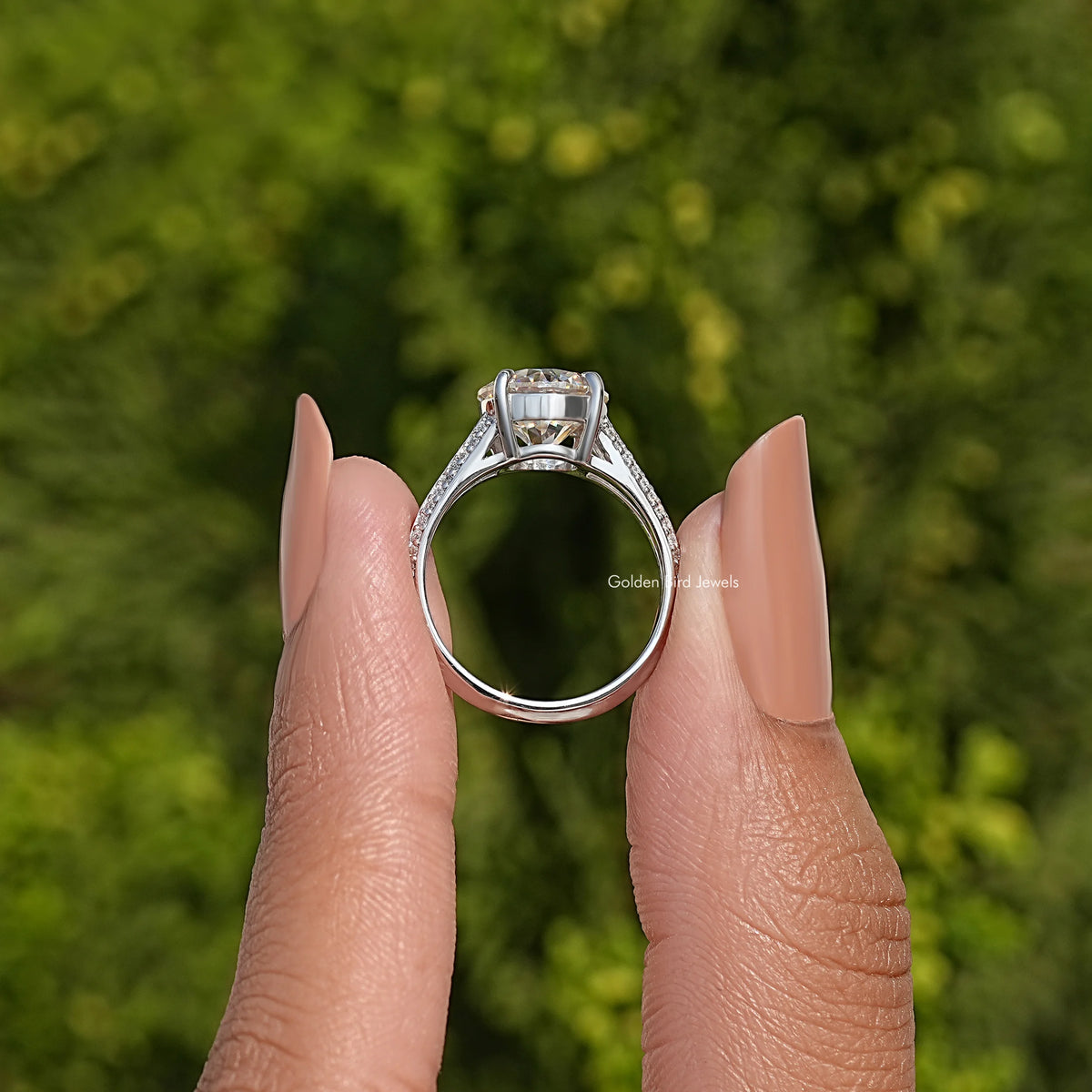 Sterling silver engagement ring showing prong-set round center moissanite and band detail