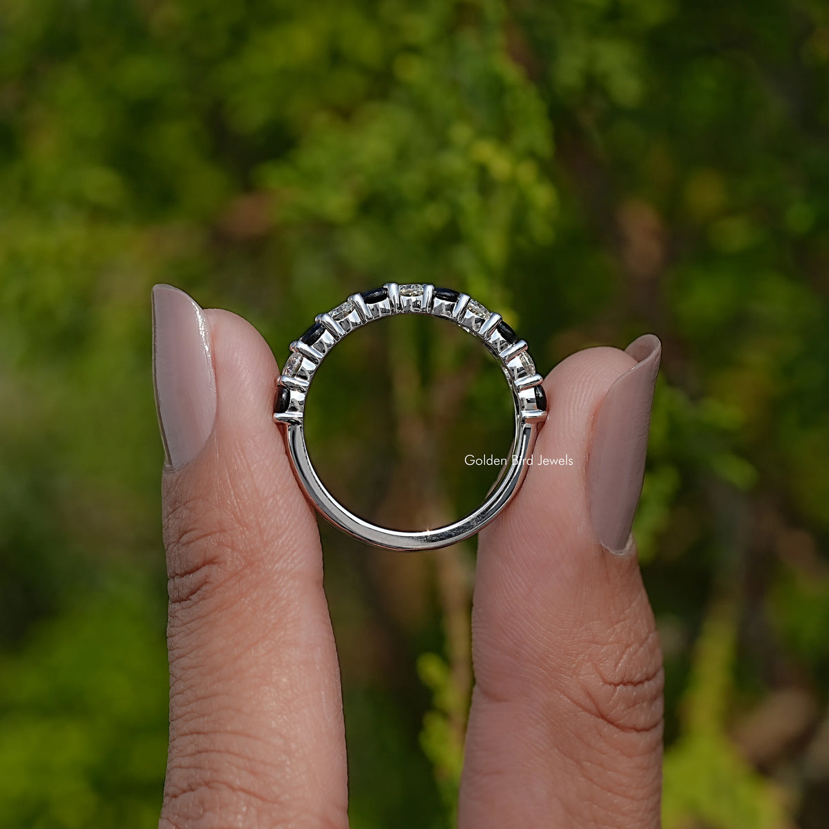 Silver eternity band open profile with prong-set round gemstones