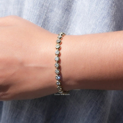 Moissanite bezel setting bracelet featuring round stones in a row, wrist close-up