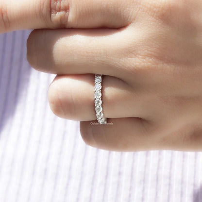 Silver half-eternity ring featuring round-cut stones along the band