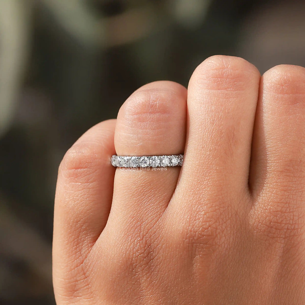 Sterling silver stacking band with prong-set round moissanite stones across the band