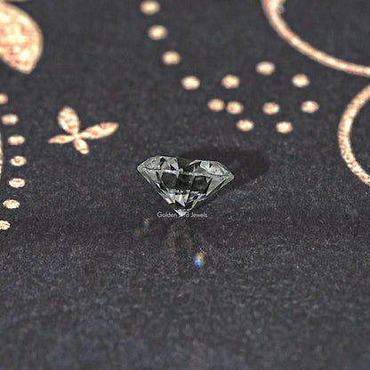 Round moissanite loose stone, small clear brilliant-cut gemstone with sharp facets.