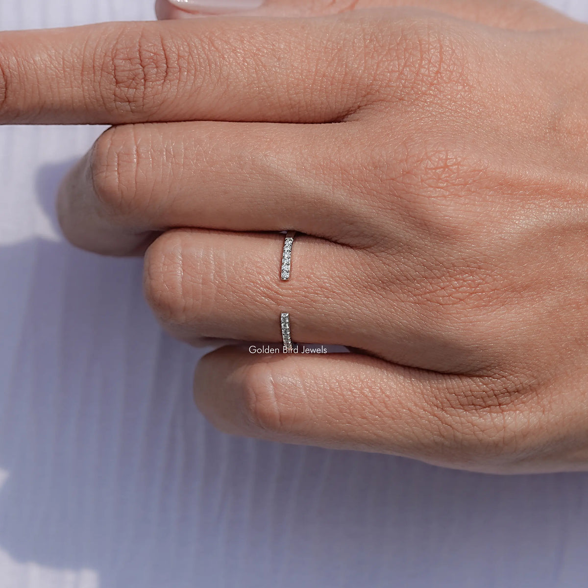 Moissanite open cuff ring with round stones on a finger