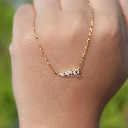 Gold-tone chain necklace with a small round-cut stone initial pendant.