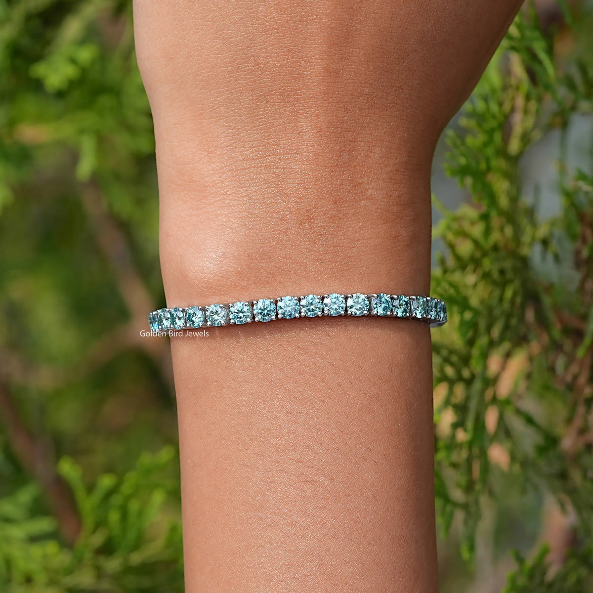 In Hand Showing View Of Blue Round Cut Moissanite Tennis Bracelet