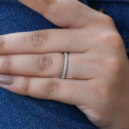 Half eternity wedding band with round moissanite stones, silver-tone, on finger