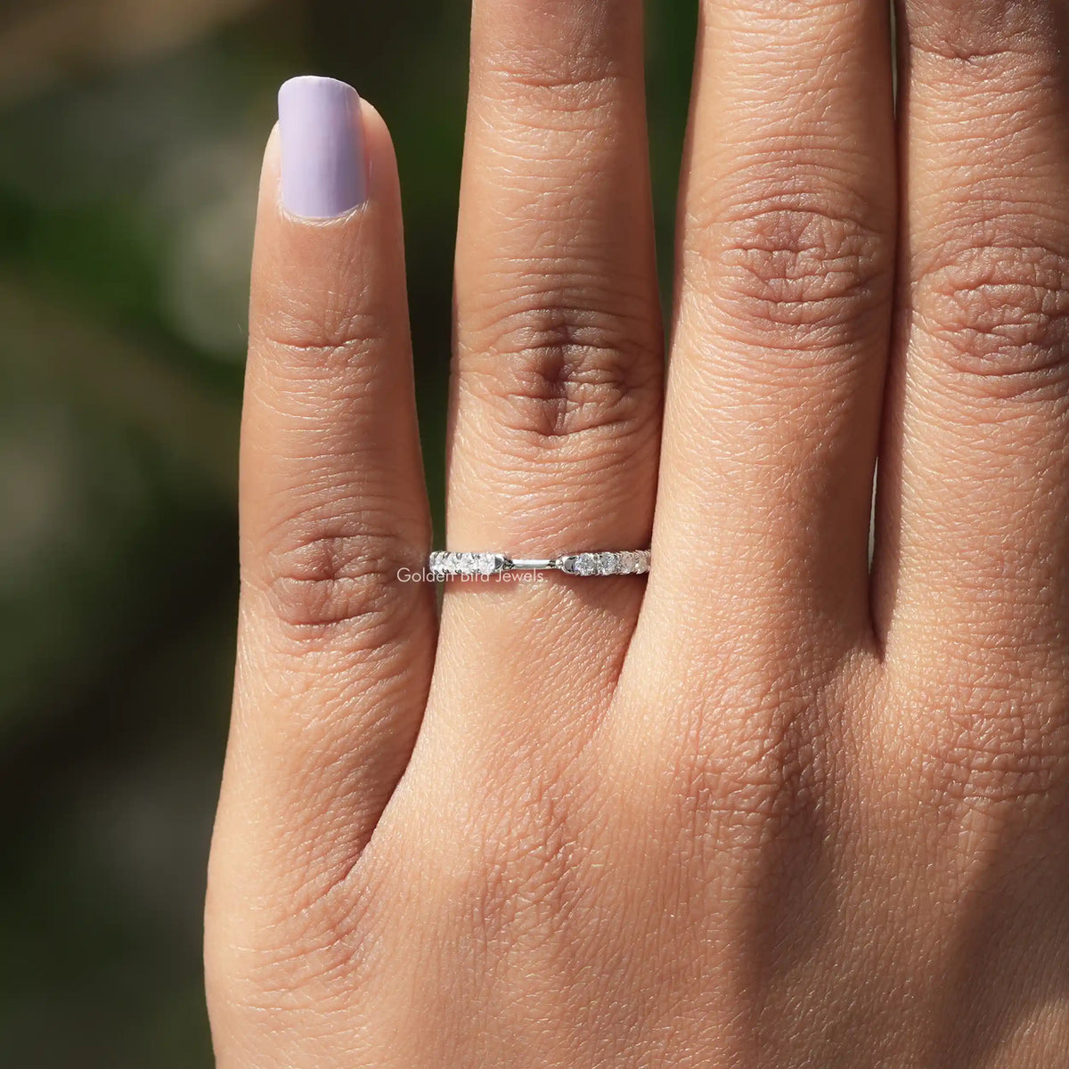 White metal half-eternity diamond band ring worn on hand