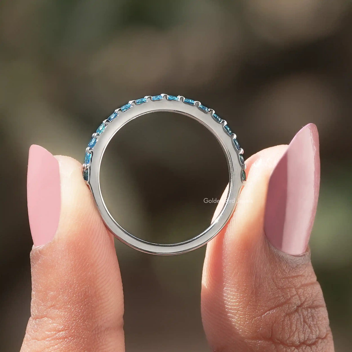 Back view of Aquamarine Blue Round Gemstone Eternity Band in secure setting 