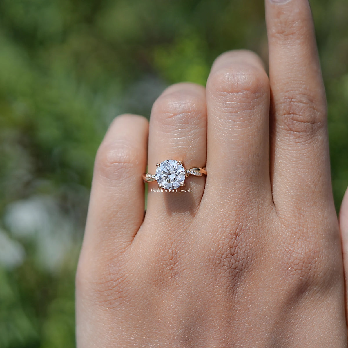 Round lab-grown diamond ring with twisted shank, prongs visible while worn