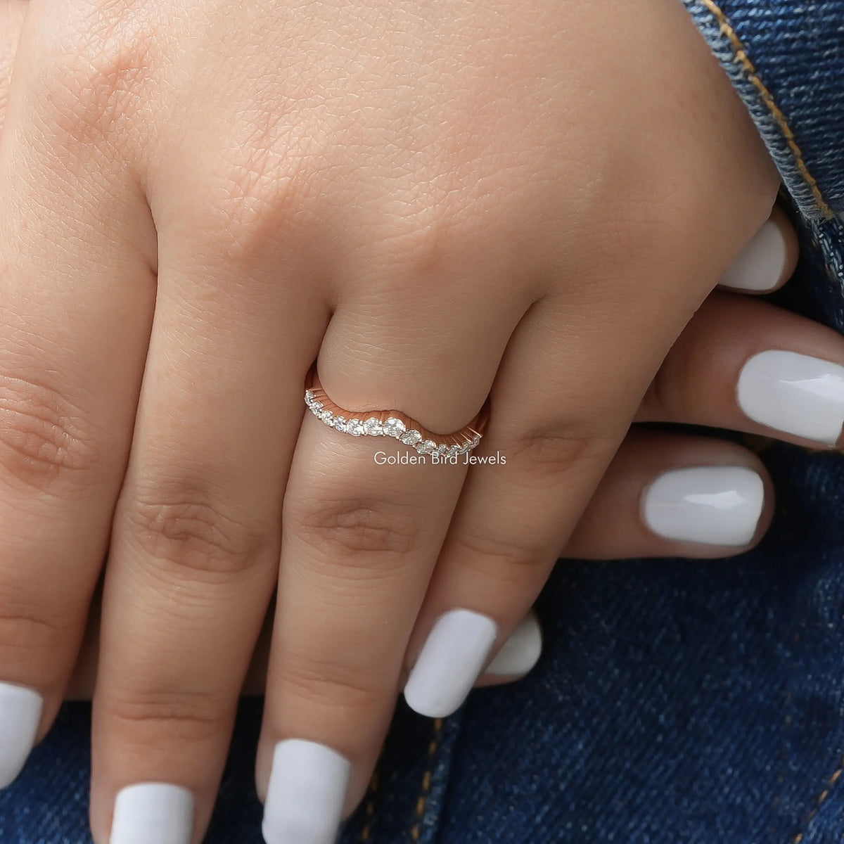 Chevron eternity band ring with round lab diamonds, close-up on finger