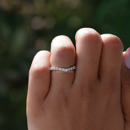 Silver diamond chevron stacking band ring viewed from front on finger