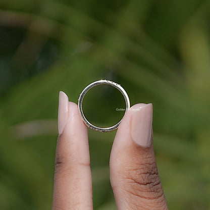 Silver-tone eternity band ring with round-cut stones, top view