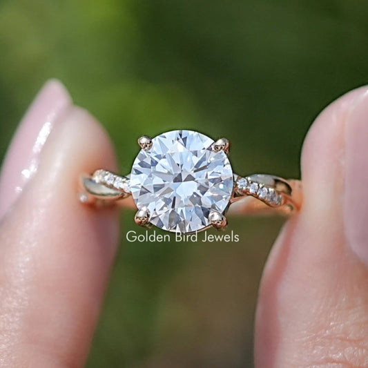Round lab-grown diamond ring with twisted shank and small side stones, gold-tone