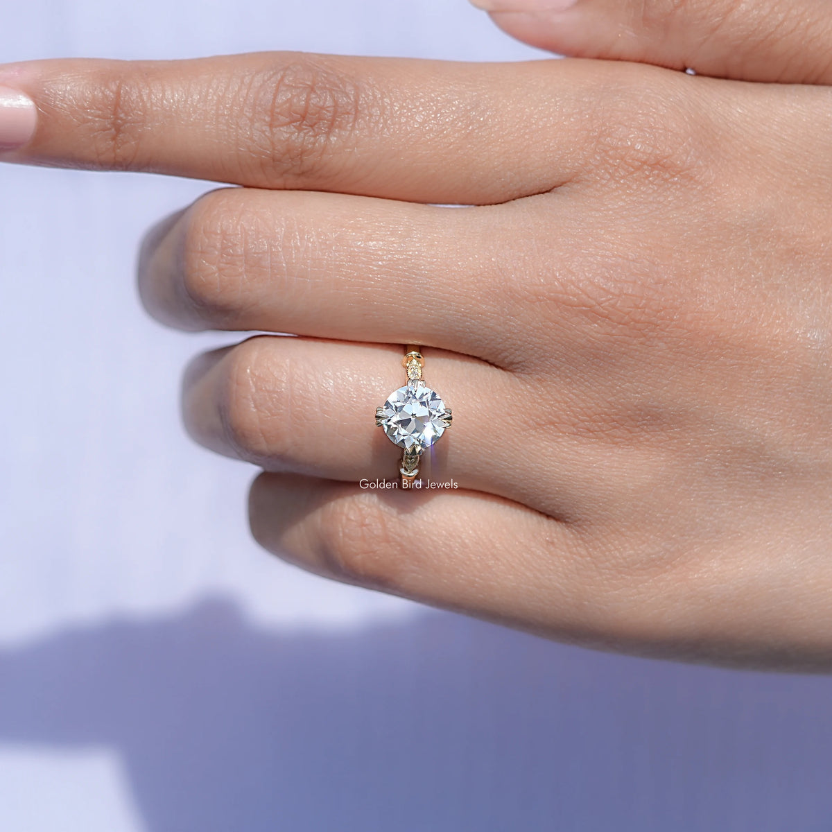 View of solitaire Old European Round Moissanite ring in prongs setting 