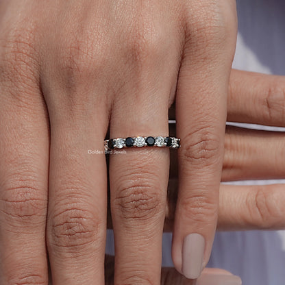 Silver eternity band with alternating round clear and dark gemstones