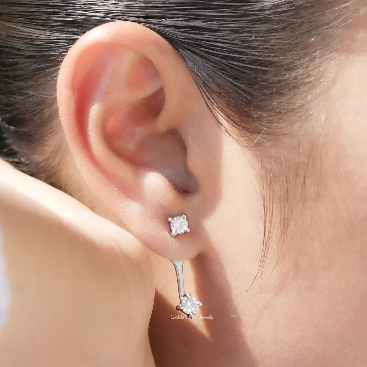 Silver-tone round stone stud with matching drop earring, screw-back style, close-up