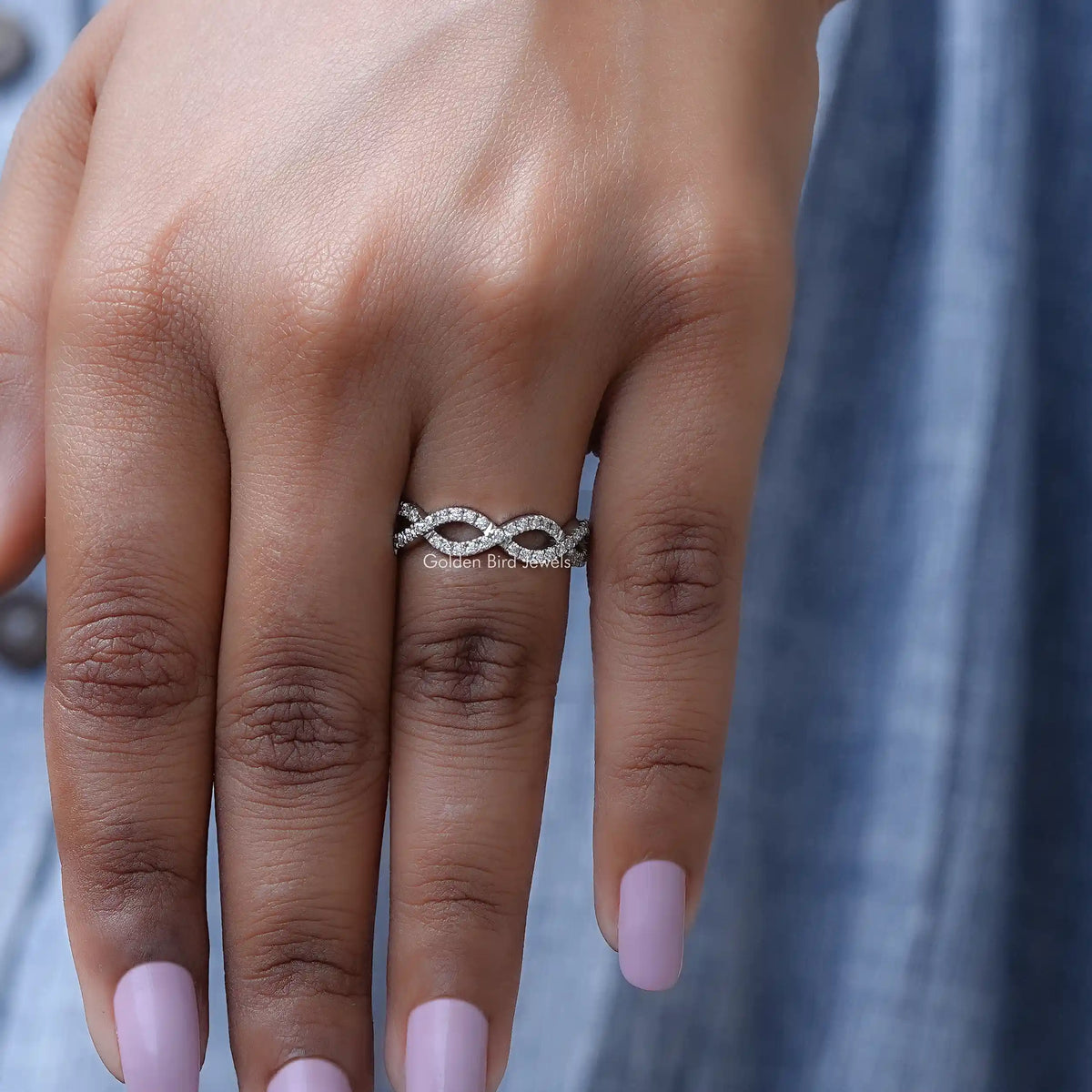 Silver infinity eternity band ring with round sparkling stones on hand