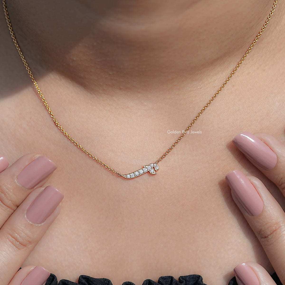 Gold-tone initial pendant necklace with round-cut stones and a clasp view.