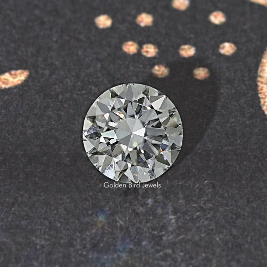 Round moissanite loose stone, top view, round brilliant-cut with bright reflective facets.