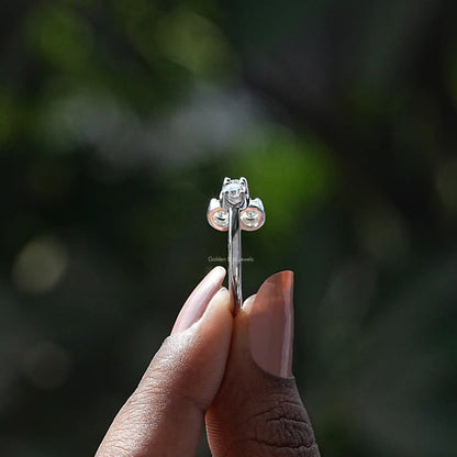 Open cuff moissanite ring with three round stones, silver-tone band close-up