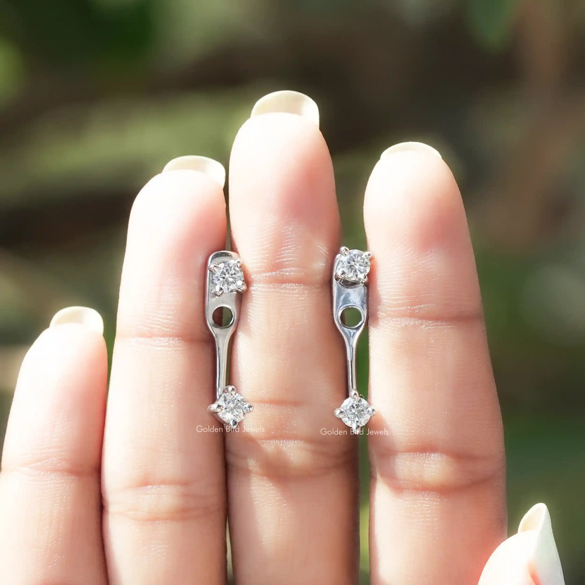 Pair of silver-tone round moissanite drop earrings with open bar and screw backs