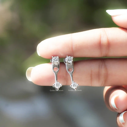 Round stone drop earrings in silver tone with screw backs, hand-held close-up