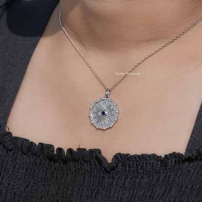 Round evil eye halo pendant on silver chain with blue center gemstone and textured rim