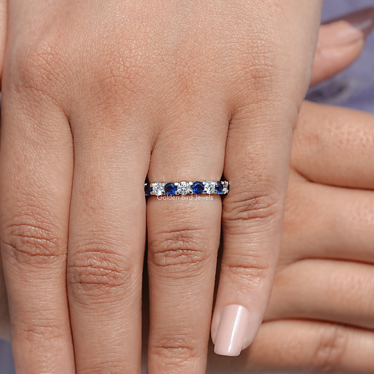 Detailed View Of Round Cut Blue Gemstone Eternity Band
