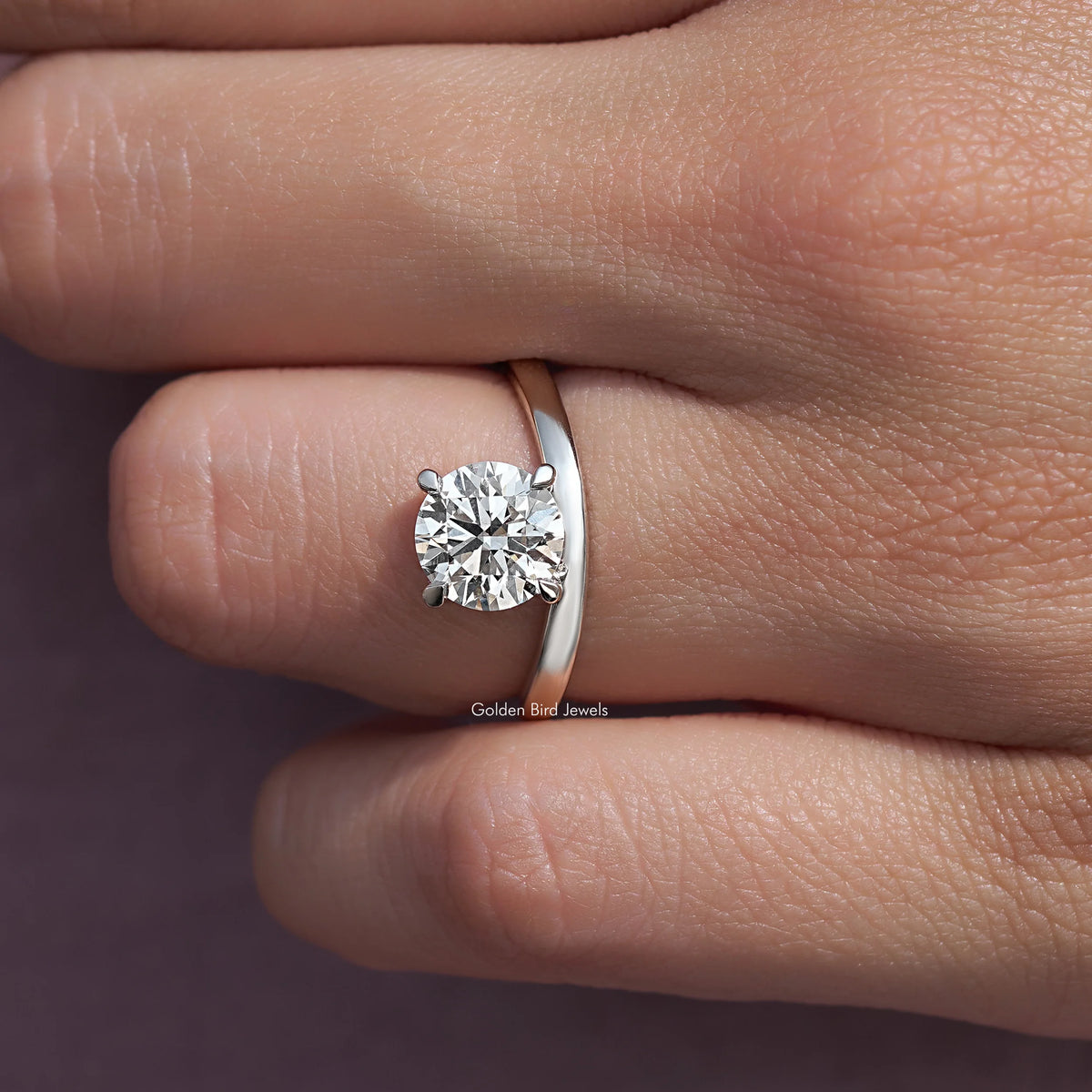 Silver curved solitaire ring with round lab diamond and smooth band, close-up