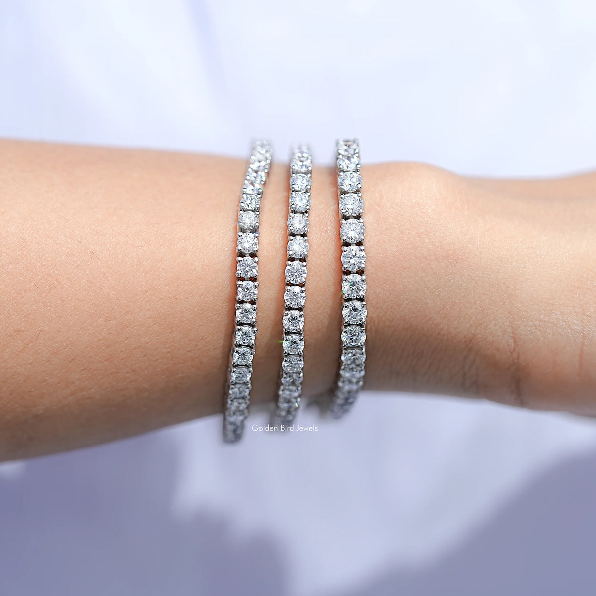 Round-cut lab diamond tennis bracelet in silver, three close-set diamond rows on wrist