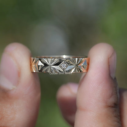 Silver band showing lab-diamond center stone and geometric starburst engraving