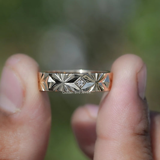 Silver band showing lab-diamond center stone and geometric starburst engraving