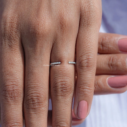 Open cuff ring with round moissanite stones on a finger