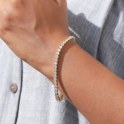 Moissanite tennis bracelet with round-cut stones, gold-tone, side view on wrist